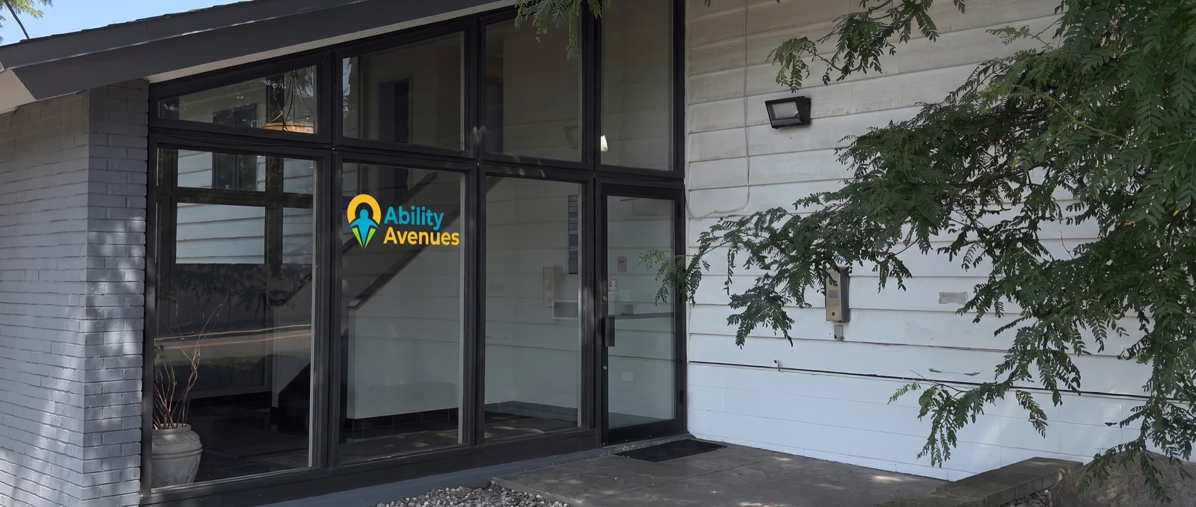 The Ability Avenues entrance at 1415 Lilac Drive North in Golden Valley, with the clinic logo on the glass doors